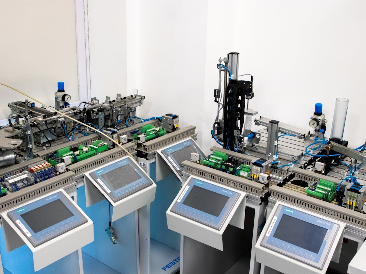 hero-img-01 High-tech industrial automation system with control panels indoors.