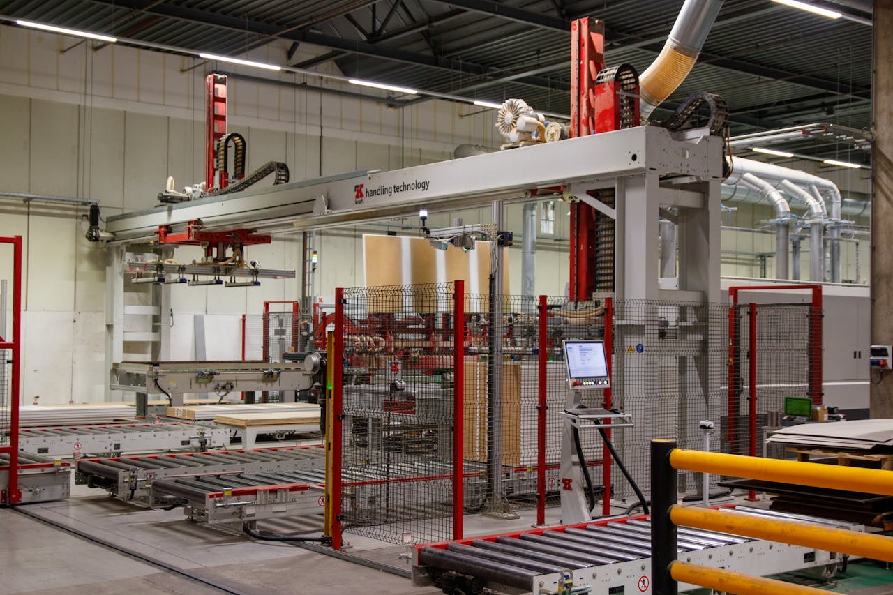 services-02 Industrial machinery with robotic arm in a modern manufacturing facility.